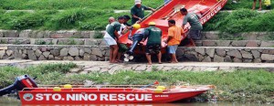 Rescue team in Marikina City, Philippines bring a boat down to the Marikina River as part of the local government's preparations for the coming of Typhoon “Chedeng